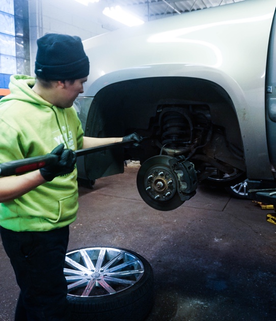 a technician working on a brake system repair in our oak forest shop