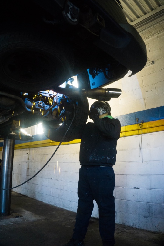 one of our experts working on a custom muffler 